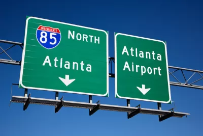 Green freeway signs for Atlanta and Atlanta airport on Interstate 85.