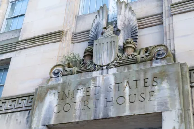 Close-up of carved United States Court House sign with eagle seal above a doorway.