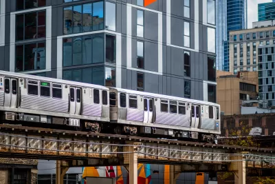 View of CHicago elevated train passing by multistory building downtown