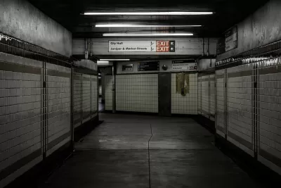 Empty hallway lined with white tile in subway station in Philadelphia, Pennsylvania.