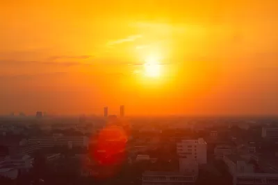 View of city skyline in red smog indicating extreme heat.