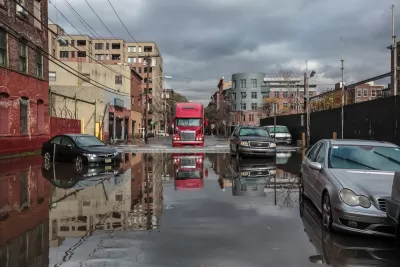 Cars passing through flooded street after Hurricane Sandy in New York City.