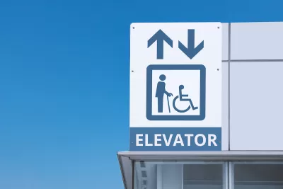 Close-up of subway station elevator sign.