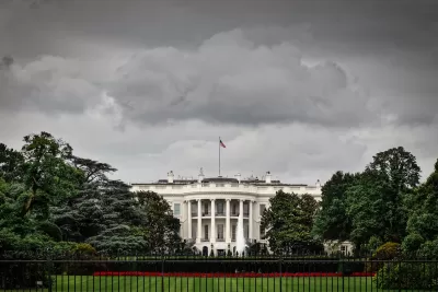 Front of White House with stormy sky above.