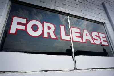 For Lease painted on window of vacant commercial space.