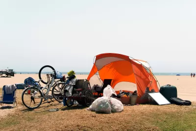 Orange tent and bicycles belonging to unhoused people at Venice Beach, California