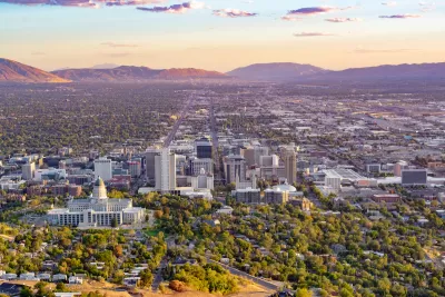 Aerial view of Salt Lake City, Utah with capitol dome in foreground again sunset sky.
