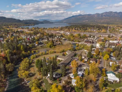 Aerial view of Whitefish, Montana with fall colors and mountains in background.