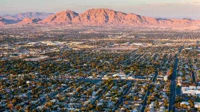 Aerial view of housingin Las Vegas, Nevada with desert mountains in background.