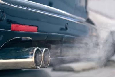 Close-up of car tailpipe emitting white smoke