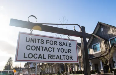 "Units for sale - contact your local realtor" sign in front of homes.