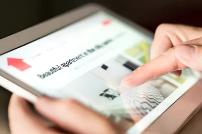 Close-up of apartment rental listing on iPad or tablet device.