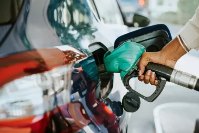 Close-up of hand filling car with gas at gas pump