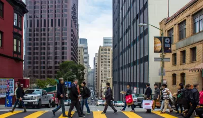 People crossing street at crosswalk in downtown San Francisco, California