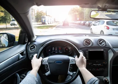 View from inside car's driver seat while driving.