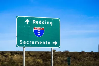 Close-up of green Interstate 5 freeway sign pointing to Redding and Sacramento.