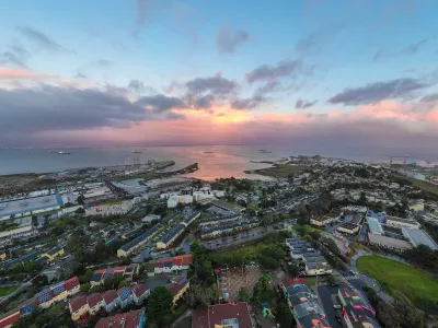 Aerial of the Hunters Point neighborhood in San Francisco, California with sun setting over the water.
