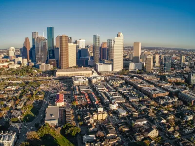 Aerial view of downtown Houston, Texas skyline with low-rise housing in foreground.