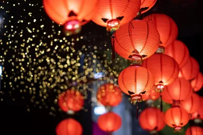Close-up of cluster of red paper Lunar New Year lanters at night.