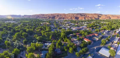 Aerial view of Moab, Utah with red mountains in background.