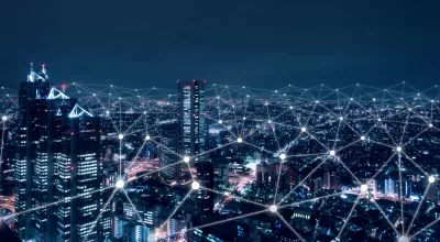 Illustration of nighttime city with white lines connecting nodes to illustrate technology and connectivity