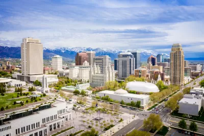 Aerial view of downtown Salt Lake City, Utah with snow-capped mountains in background.