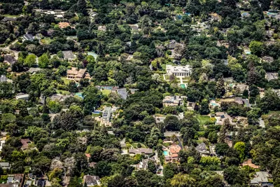 Aerial view of large houses in large yards surrounded by trees in Palo Alto, California