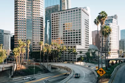 View of 110 freeway with downtown Los Angeles buildings in background.