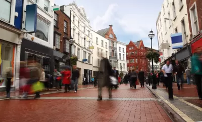Pedewstrianized street paved with red bricks flanked by historic four-story buildings in Dublin, Ireland