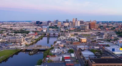 Aerial view of Newwark, New Jersey at sunset with river in foreground.