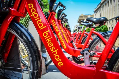 Close-up of red Capital Bikeshare bikes parked at statio on sidewalk in Washington D.C.