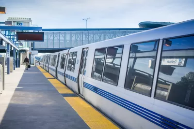 White BART public transit train at Coliseum station in Oakland, California.