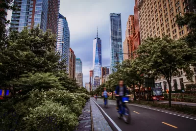 Blurred view of cyclists riding in protected bike lane 