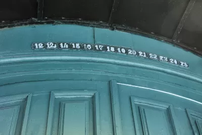 Green wall with floor or apartment numbers missing number 13, goes from 12 to 12 1/3 to 14 instead.