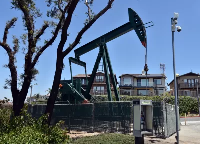 Fenced-in oil pump in residential neighborhood