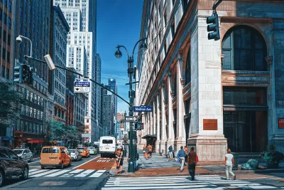 Busy street with red painted bus lane in midtown Manhattan, New York City.