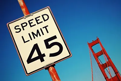 Close-up on 45 mph speed limit sign with part of Golden Gate Bridge visible in background, San Francisco, California.