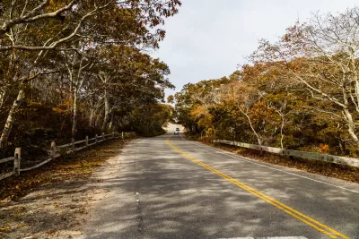 Route 6 highway in Massachusetts with fall trees on either side