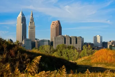 CLeveland, Ohio downtown skyline seen from grassy field.