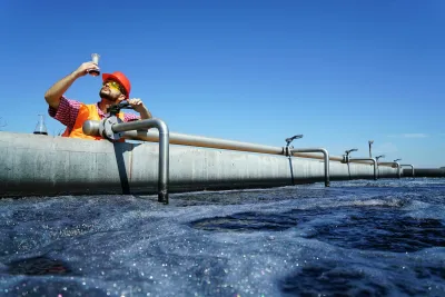 An engineer controlling a quality of water ,aerated activated sludge tank at a waste water treatment plant. 