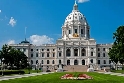 Minnesota state capitol building with red flowers on green front lawn