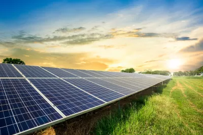 Photovoltainc solar panels in green grass field.