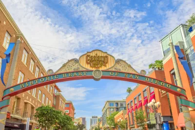 Arched entrance sign over street to San Diego's historic Gaslamp Quarter with slogan "historic heart of San Diego."