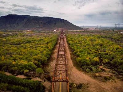 Aerial view of Gillespie Bridge with metal framing and black rock mesa in background in Gillespie, Arizona.