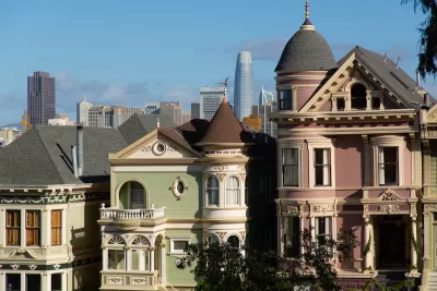 Ornate Victorian San Francisco houses with modern high-rises in background.