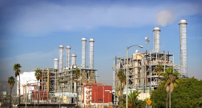 Power plant with palm trees in foreground in California.