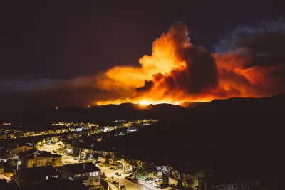 Night view of wildfire burning near residential area in California