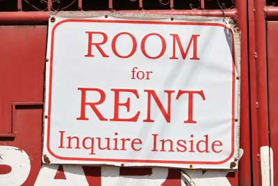 Red on white 'Room for Rent, Inquire Inside' sign
