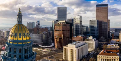 Aerial view of gold state capitol dome in Denver, Colorado and Denver skyline.