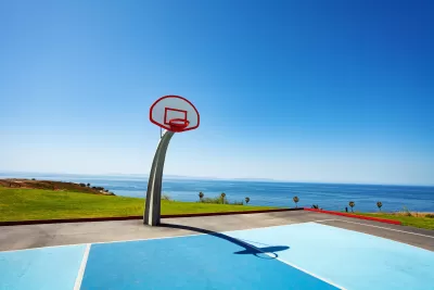 Beachside basketball couty with ocean view and blue painted court at Angel Gate Park in Los Angeles, California on a sunny day
